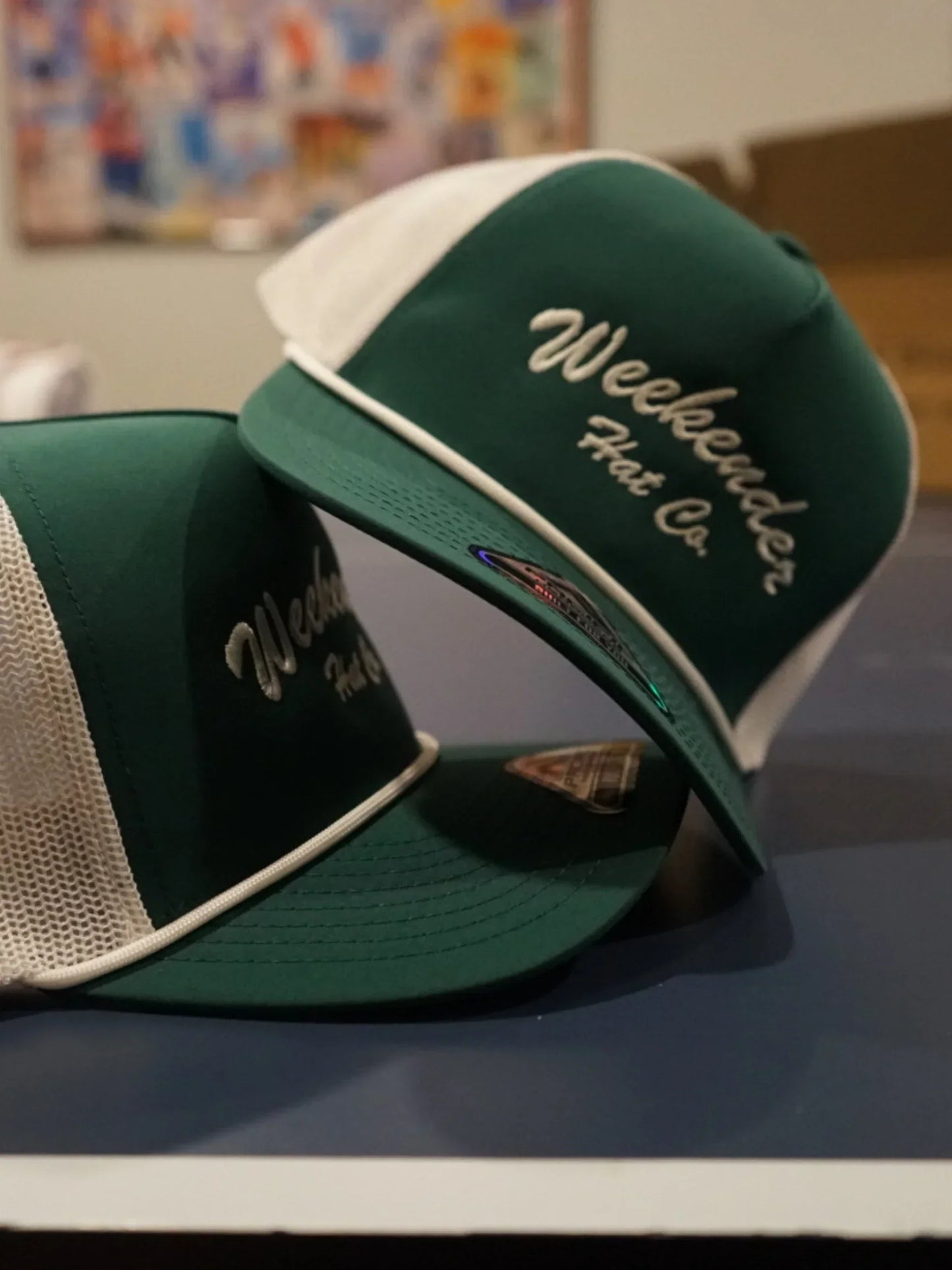 A photo of two dark green trucker hats - Weekender Hat Co.