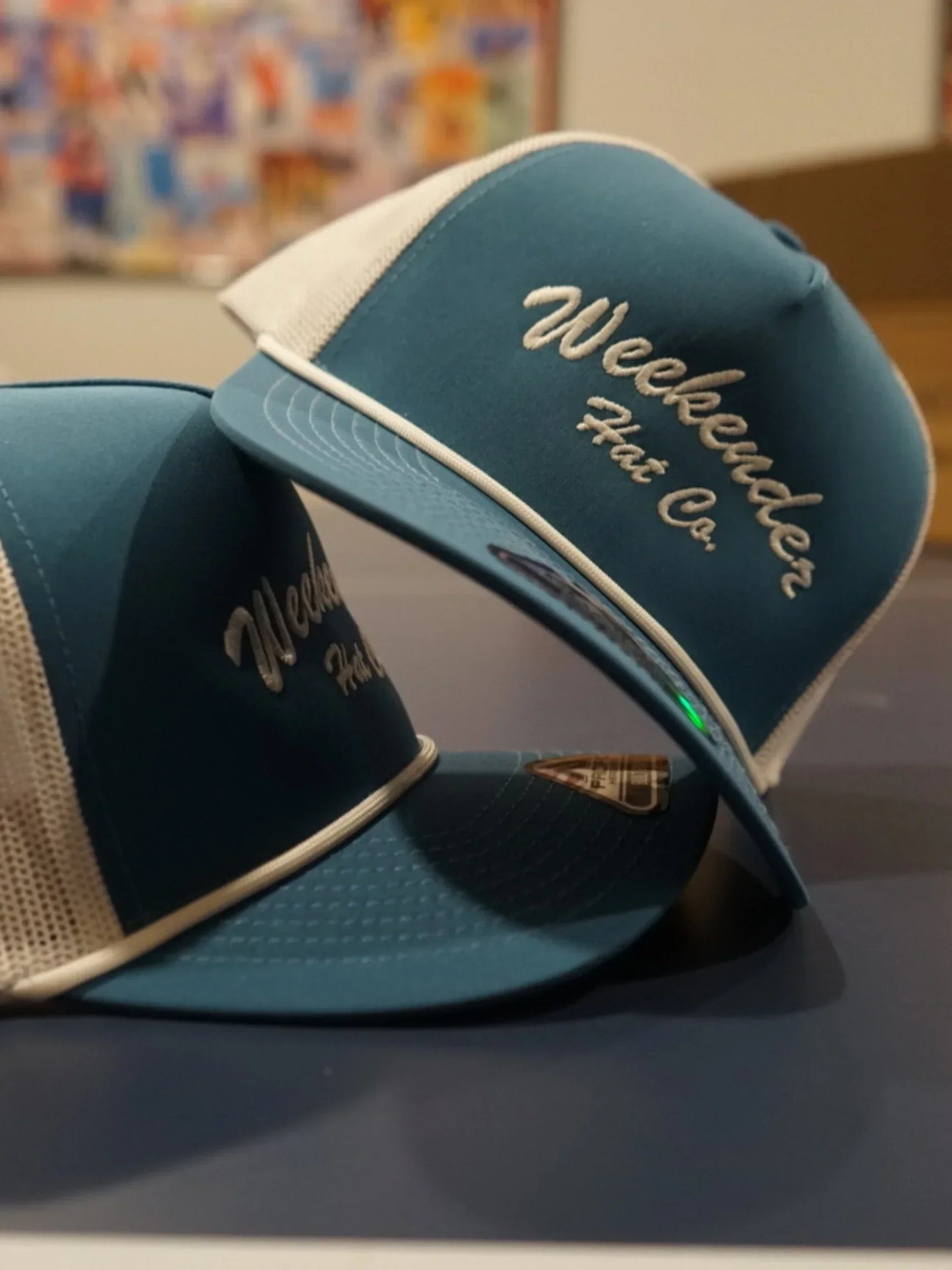 A photo of two blue trucker hats - Weekender Hat Co.