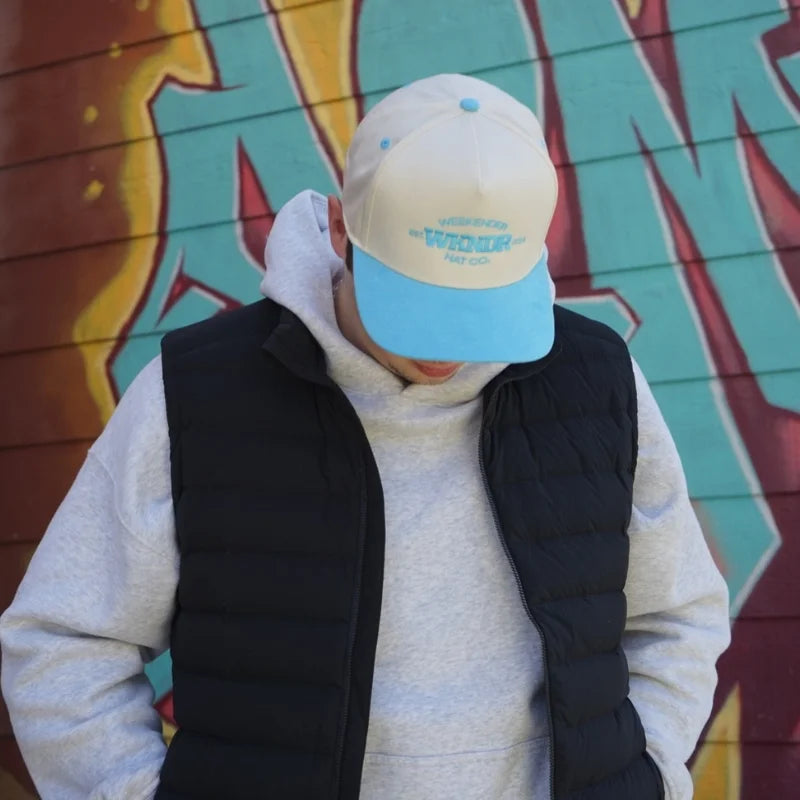 A Blue Vintage Hat from Vintage Threads collection by Weekender Hat Co. being worn in Uptown Waterloo